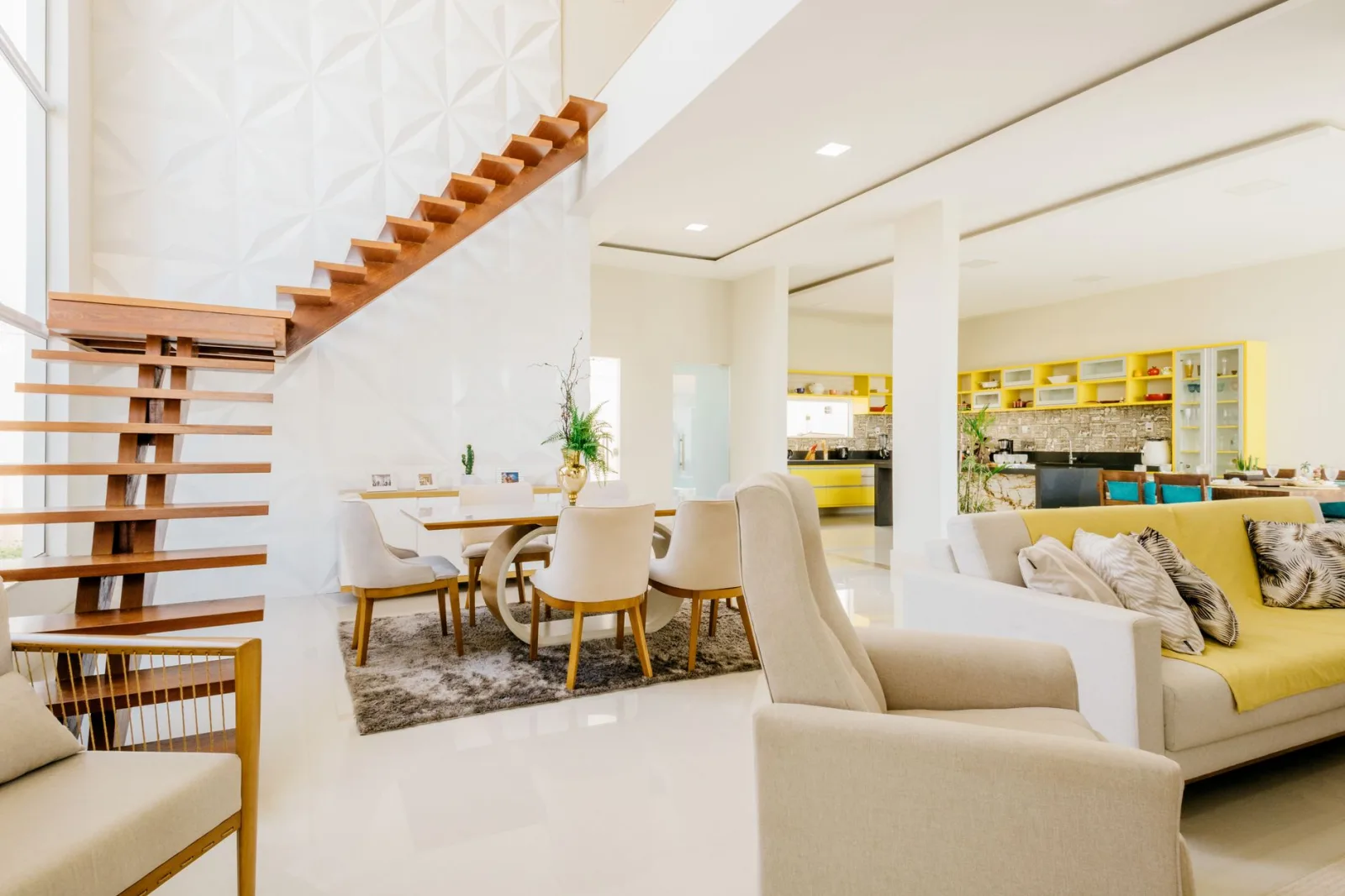 Spacious modern living room featuring elegant furniture and an open kitchen.