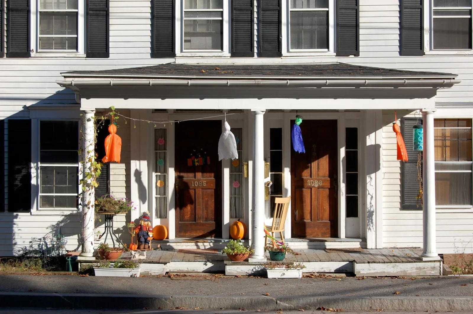 Cozy porch decorated with festive Halloween decorations and vibrant colors.