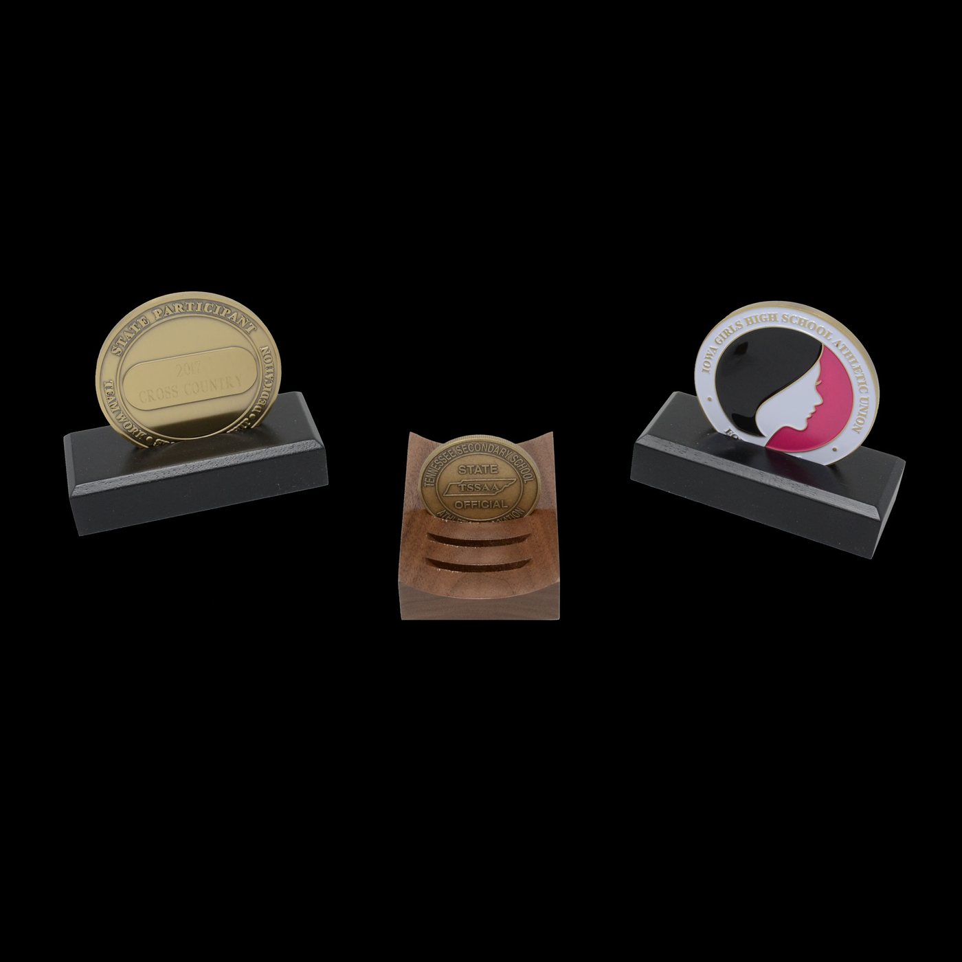 Engraved presentation coins and medallions mounted on wood and black desk bases
