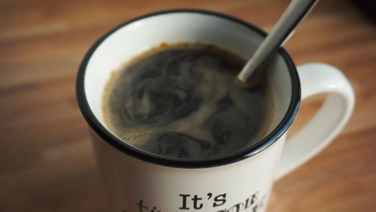 A ceramic mug of freshly poured coffee